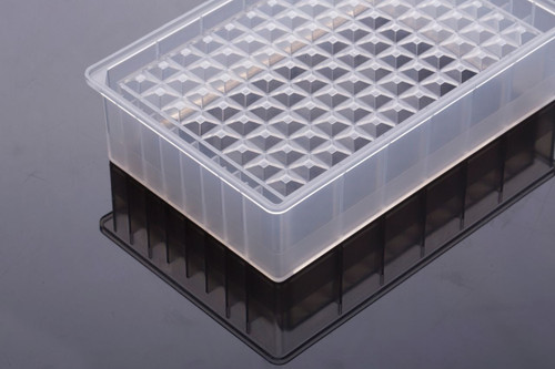 Clear polypropylene 96-well reservoir microplate on a reflective surface, shown at an angle.