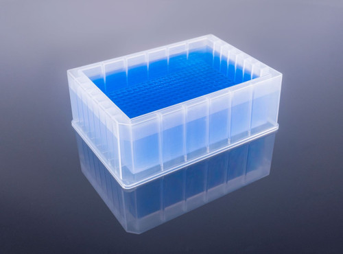 Translucent plastic 384-trough reservoir microplate filled with blue liquid, viewed from a high angle on a reflective