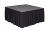 Top rated 16" High Black Shirred Pleat Wyndham Flame Retardant Polyester Stage Skirting with the Loop Side Fastener.  - Attached to a square stage.