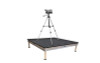 Quik Stage 4' x 4' x 8" high professional quality camera platform riser with black polyvinyl non-skid deck surface- Front Angle View with a Camera