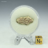Back-facing Trinitite 1.4 grams, green and black on a display stand with sizing cube, for sale at Sciencemall-USA