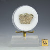 Green trinitite, Specimen ID84592 facing back on a display stand, Sciencemall-USA