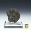 Manganese nodule with a gold sizing cube and square plexiglass clear beveled riser, specimen #86197.
