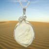 Mammoth ivory jewelry cameo mother and child ivory pendant on a chain   shown on red dunes, sky, Sciencemall-USA Mammoth ivory jewelry cameo mother and child ivory pendant on a chain   shown on red dunes, sky, Sciencemall-USA