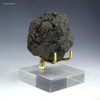 Complete manganese nodule, 129 grams, displayed side-facing on a plexiglass stand, available at Sciencemall-USA.