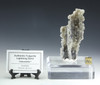 Fulgurite lightning sand called "Interstellar" shown on a clear crystal display base with description tag and gold sizing cube.