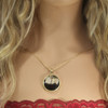 Rising from the ashes phoenix bird jewelry pendant 14k gold shown on a model with blonde hair and red camisole.