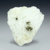 Helvite, also called helvine mineral shown with 4 crystals on a graduated background. This helvite is from Brazil.