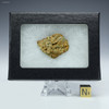 Back-facing Trinitite specimen ID: 11058, on a display stand, with sizing cube, Sciencemall-USA