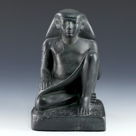 Egyptian seated scribe Amenemhat statue with legs crossed hand on knee with hieroglyphics