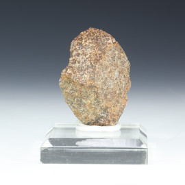 Tranquillityite, first mineral found on the Moon named after Tranquility base Apollo Mission shown front on a plexiglass riser.