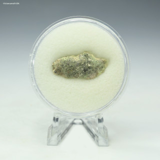 Front-facing Trinitite 1.4 grams, green and black on a display stand, for sale at Sciencemall-USA