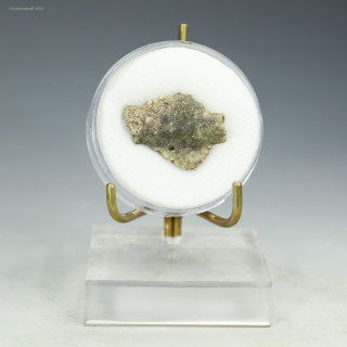 Front-facing Trinitite, green, black, red, metal, 2.45 grams, shown on a display stand, at Sciencemall-USA