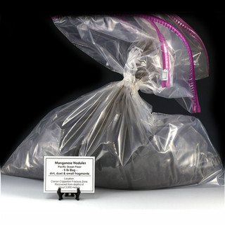 Polymetallic manganese nodules from the Clarion-Clipperton Fracture Zone shown in a 5 lbs plastic bag with a description tag, on a black stand.