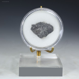 Front-facing rheniite, a rhenium element-containing mineral in a disc on a display stand, for sale at Sciencemall-USA