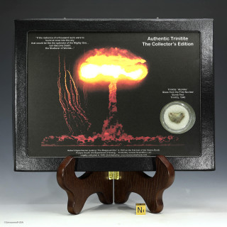 Trinitite atomic glass green and black collectible in a riker display case with colorful atomic bomb graphic, at Sciencemall-USA