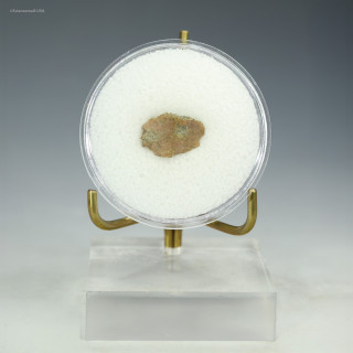 Front-facing green, red, black, metal trinitite, 0.56 grams on a stand, for sale at Sciencemall-USA