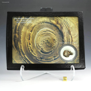 Richat structure Eye of the Sahara volcanic breccia lapilli with artwork and rare rock specimen, shown on a display stand, sold by Sciencemall-USA.