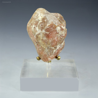 Front-facing Pook's pebble 40.5 grams on a display base, Sciencemall