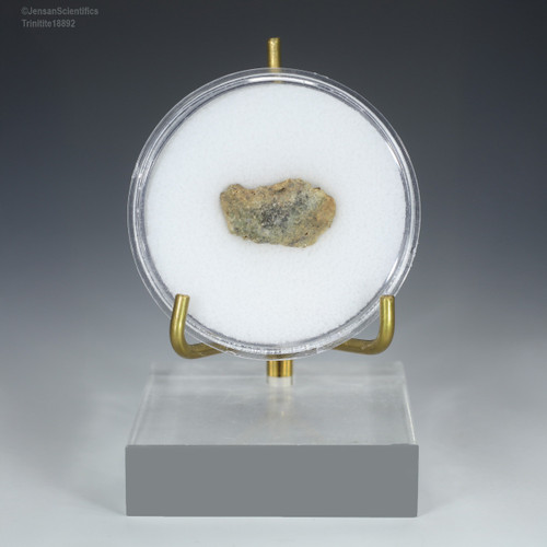 Front-facing trinitite glass red, green, black with metallic flakes 0.89 grams for sale at Sciencemall-USA