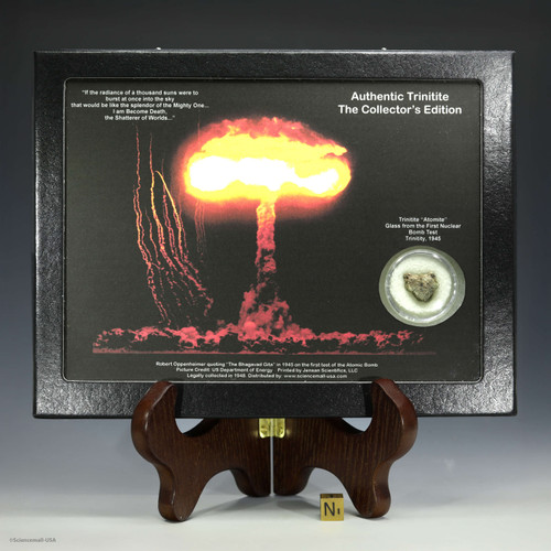 Authentic trinitite Riker display with artwork and quote, 0.96 grams green minor black on a display stand with sizing cube