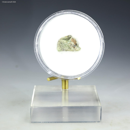 Trinitite green front facing 15829 in a disk on a display stand at Sciencemall-USA.