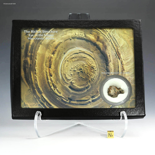 Richat structure Eye of the Sahara volcanic breccia lapilli with artwork and rare rock specimen, shown on a display stand, sold by Sciencemall-USA.
