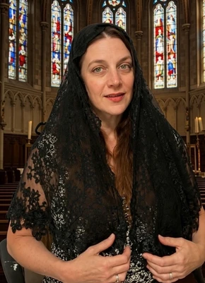 "Front view of the St. Louis Collection Lily veil, a beautiful black mantilla with 3D floral lace trim.