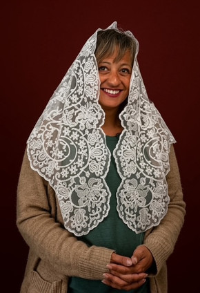 Front view of the Authentic Spanish Caterina Mantilla chapel veil in soft white lace, draped as a Catholic mass veil highlighting its intricate floral embroidery and frame.