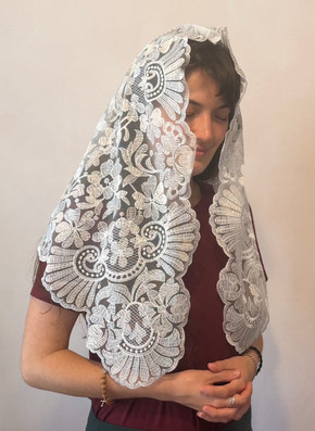 Authentic Spanish Avila Mantilla features a striking motif of scrollwork, flowers, swirls and scallops blending into a beautifully crafted white veil.