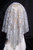 Silver "Woman wearing a long floral lace Catholic mantilla"