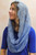 Side view of a woman wearing the Marian Blue infinity veil, showing how the soft lace gently frames the face.