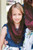 Young girl wearing a Burgundy starter infinity Catholic veil for girls, comfortably wrapped around her shoulders.