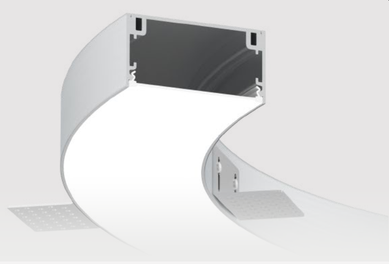The VT family of luminaires is available in four different widths: 35, 50, 80, and 100 millimeters. They utilize the same product for both surface-mounted and suspended installations, with the addition of an "L" bracket for trimless recessed mounting. These luminaires offer direct lighting options, including high-efficiency LED boards and 24V SMD LED edge-lit solutions. They are designed to deliver fully customized solutions for projects, with a strong emphasis on meeting client needs from conceptualization to completion.
