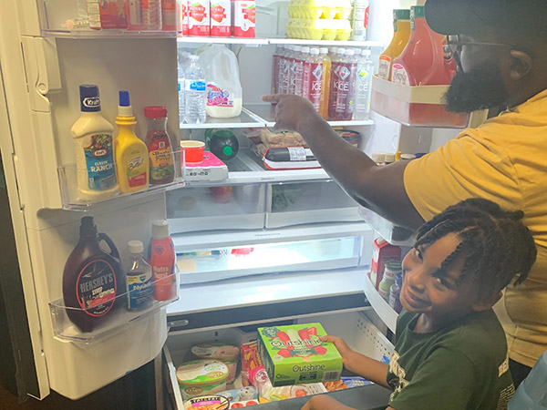 Allyson Silas's family takes a look inside their new refrigerator.