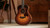 Taylor GS Mini-e Rosewood SB standing in a room, showing the full sunburst body