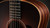 Upper bout and ebony fingerboard end against the layered rosewood side