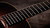 Ebony fingerboard with dot inlays running the length of the neck