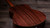 Rear three-quarter view showing the layered Indian rosewood back grain