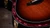 Crelicam ebony bridge and Micarta saddle, guitar resting in the included hardshell case