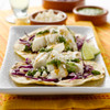 Yummy-looking halibut tacos on a rectangular platter.