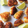 Breaded Alaska cod chunks with lime wedges.