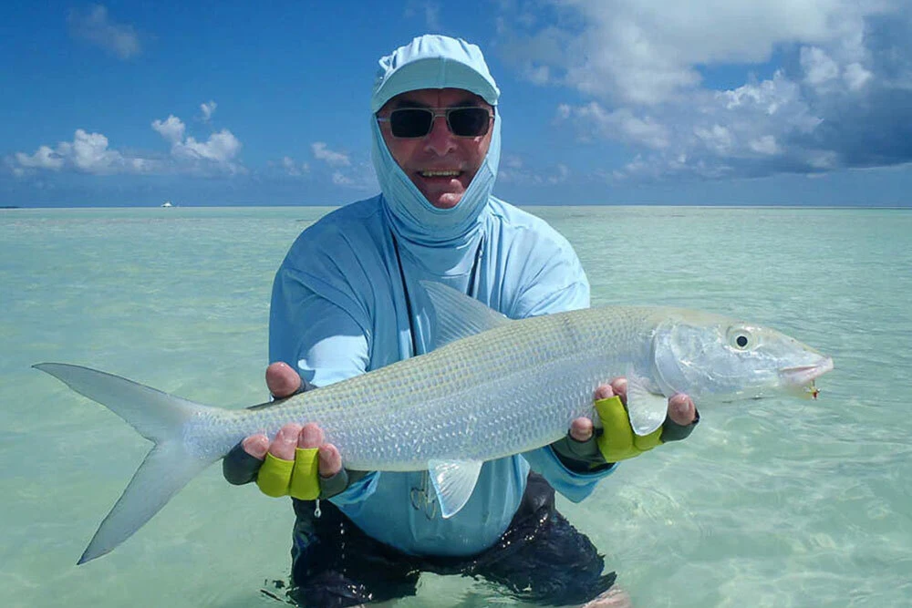 Man w/ bonefish in Alphonse Island.