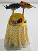 RESALE SHOP - OOAK 1:12 Yellow Table With Patterned Skirt And Hat Displays