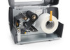 Zebra ZT231 Industrial Barcode Printer interior view showing media path and printing barcode labels with thermal transfer technology