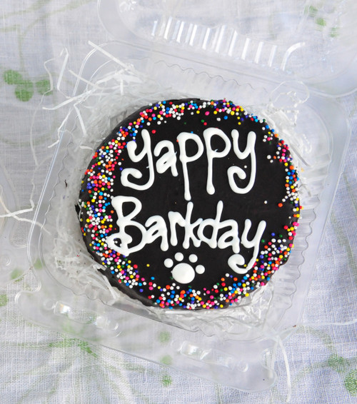 Brownie cake covered in carob frosting with white lettering