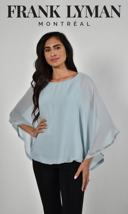 Brunette model wearing the Frank Lyman aqua chiffon overlay blouse with bling