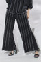 Model wearing the Hollywood Emory Palazzo Pants from Kozan in the colors black and white