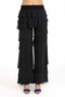 Front of the Tiered Ruffle Cha-Cha Pants from Isle by Melis Kozan in the color black