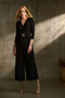 Model wearing the Silky Knit Wrap Jumpsuit from Joseph Ribkoff style 243079 in the color black